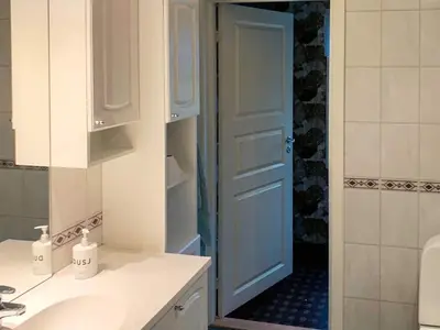 a bathroom with a sink and a blue door at 10 person holiday home in Brekke in Brekke