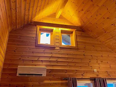a room in a log cabin with two windows at 6 person holiday home in Brekke in Brekke
