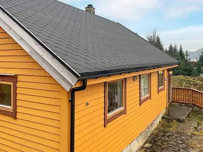 a yellow house with a black roof at 6 person holiday home in Brekke in Brekke