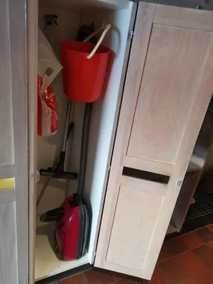 a cupboard with a door and a bucket at Stor barnevennlig leilighet in Hovden