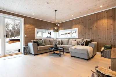 a living room with a couch and a table at Lykkeli in Stranda