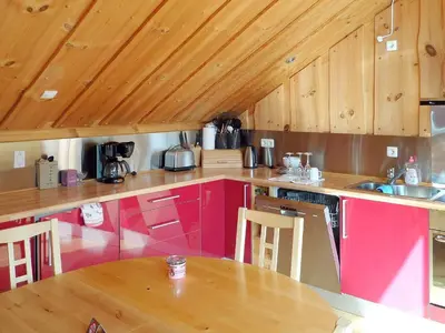 a kitchen with pink cabinets and a wooden ceiling at 6 person holiday home in EIDSVÅG-By Traum in Eidsvåg