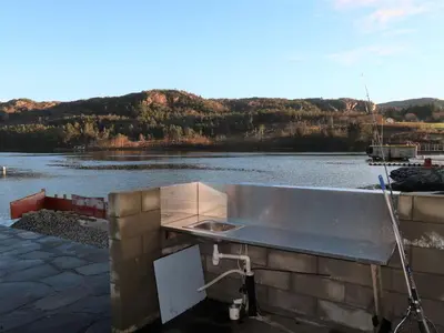 a stainless steel sink in front of a body of water at Holiday Home Jektastøo by Interhome in Nordhuglo