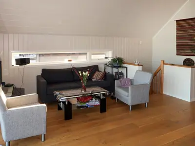 a living room with a couch and two chairs and a table at Holiday Home Jektastøo by Interhome in Nordhuglo