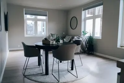 a living room with a dining room table and chairs at Odda Apartments - 2BR & 3BR - Parking - T32 in Odda