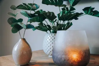 two vases sitting on a table with plants in them at Odda Apartments - 2BR & 3BR - Parking - T32 in Odda
