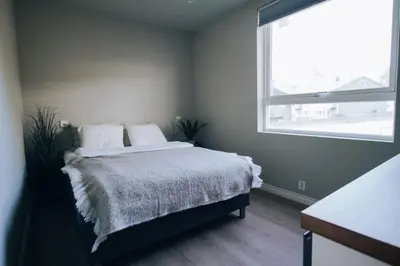 a bedroom with a bed with a large window at Odda Apartments - 2BR & 3BR - Parking - T32 in Odda