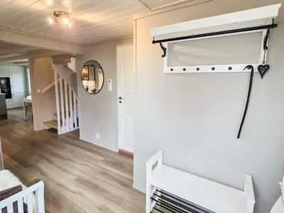 a room with a white wall with a white closet at 6 person holiday home in Bud in Bud