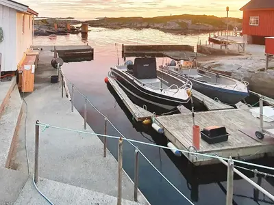 two boats docked at a dock in the water at 6 person holiday home in Bud in Bud