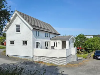 a white house with a gray roof at 6 person holiday home in Bud in Bud