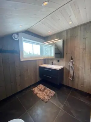 a bathroom with a sink and a window at Villa Solsiden Geilo in Geilo