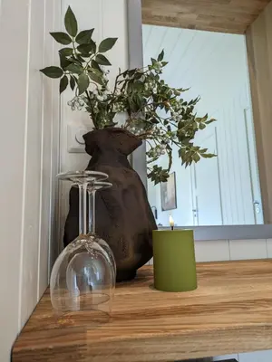 a vase and a candle on a wooden table at Villa Fregn in Ljørdal