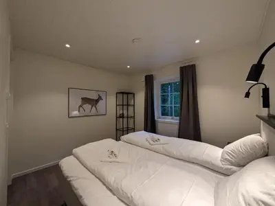 two white beds in a room with a window at Villa Fregn in Ljørdal