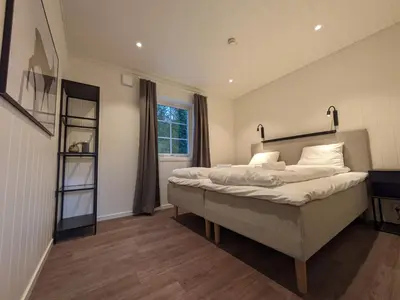 a bedroom with a large bed and a window at Villa Fregn in Ljørdal