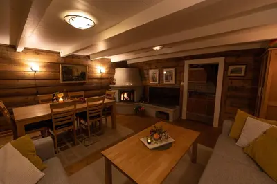 a living room with a couch and a table and a fireplace at Flotunet - Anestova in Stryn