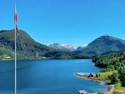 a view of a lake with an american flag at 8 person holiday home in Austefjorden in Austefjorden