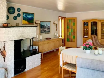 a living room with a fireplace and a table at 8 person holiday home in Austefjorden in Austefjorden