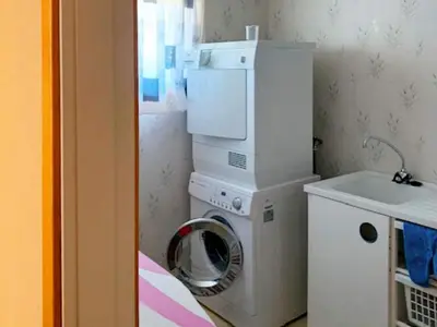 a small bathroom with a washing machine and a sink at 8 person holiday home in Austefjorden in Austefjorden