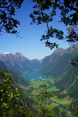 a view of a valley with a lake in the mountains at Melkevoll Bretun Camping in Briksdalsbre