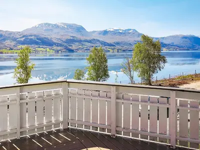 a balcony with a view of a lake and mountains at 5 person holiday home in averøy in Stokke