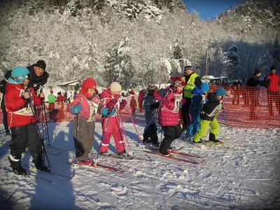 a group of children on skis in the snow at Hardanger Feriesenter Sjusete in Norheimsund