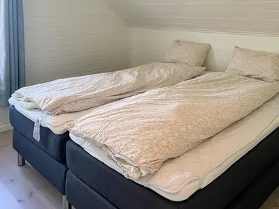 a large bed in a room with at 8 person holiday home in Svelgen in Svelgen