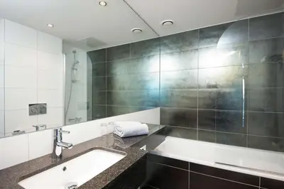 a bathroom with a sink and a mirror at Scandic Ørnen in Bergen