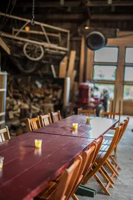 a long wooden table with chairs in a room at Lensmansgarden in Innfjorden