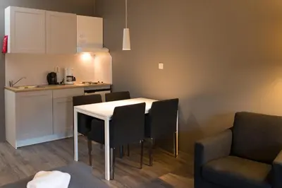 a kitchen and dining room with a table and chairs at Oppdal Gjestetun Hotell in Oppdal
