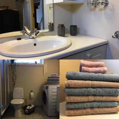 a bathroom with a sink and a pile of towels at Bakka in Bakka