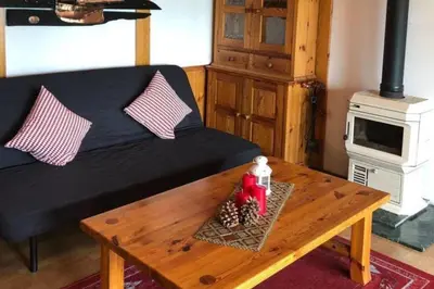 a living room with a couch and a coffee table at Cottage - Sleeps 6 - Parking - Patio in Ytteroy