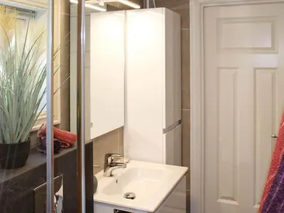 a bathroom with a sink and a mirror at 6 person holiday home in AVERØY in Stein