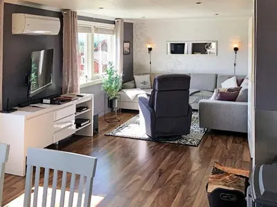 a living room with a couch and a tv at 6 person holiday home in AVERØY in Stein