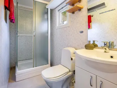 a bathroom with a toilet and a sink and a shower at 6 person holiday home in AVERØY in Stein