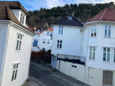 a group of white houses in a city at Skansen Apartments in Bergen