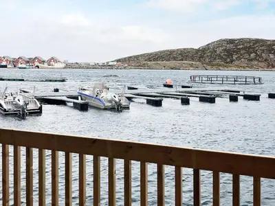 a group of boats docked at a dock in the water at 6 person holiday home in Kverva in Dyrvik