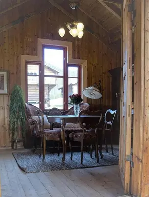 a dining room with a table and some chairs at Bolkesjø Gaard in Notodden
