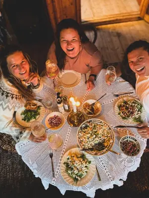 a group of people sitting around a table with food at Bolkesjø Gaard in Notodden