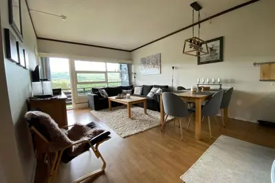 a living room with a table and a couch at Beste beliggenhet på Geilo. in Geilo