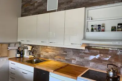 a kitchen with white cabinets and a sink at Beste beliggenhet på Geilo. in Geilo