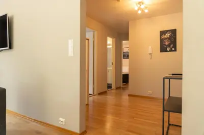 an empty living room with a table and a dining room at Stryn Apartments - City Center - Modern Suites in Stryn