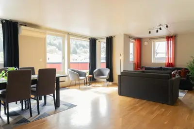 a living room with a couch and a table at Stryn Apartments - City Center - Modern Suites in Stryn