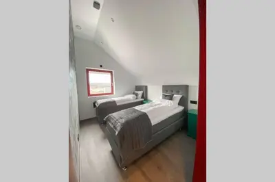 a bedroom with two beds in a room at Flatanger Turkish Bath apartment in Lauvsnes