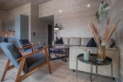 a living room with a couch and a table at Panorama 13 - beautiful view! in Sogndal