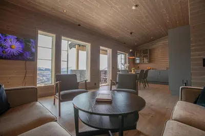 a living room with a table and chairs at Panorama 13 - beautiful view! in Sogndal