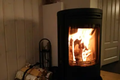 a stove with a fire in it in a room at Apartment Gaustablikk in Gaustablikk