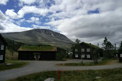 a mountain in the distance with a house and a building at Apartment Gaustablikk in Gaustablikk