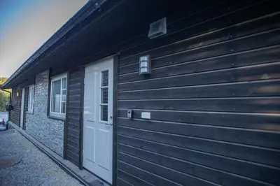 a wooden building with a door and a white door at Hodlekve Panorama 5 - amazing view in Sogndal