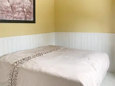 a white bed in a corner of a room at 6 person holiday home in Aure-By Traum in Aure