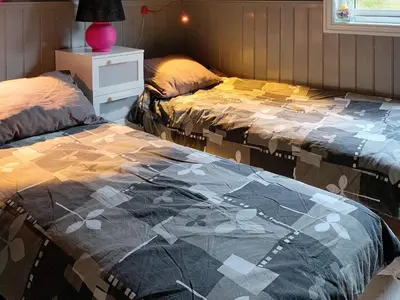 two beds sitting next to each other in a bedroom at 6 person holiday home in Aure-By Traum in Aure